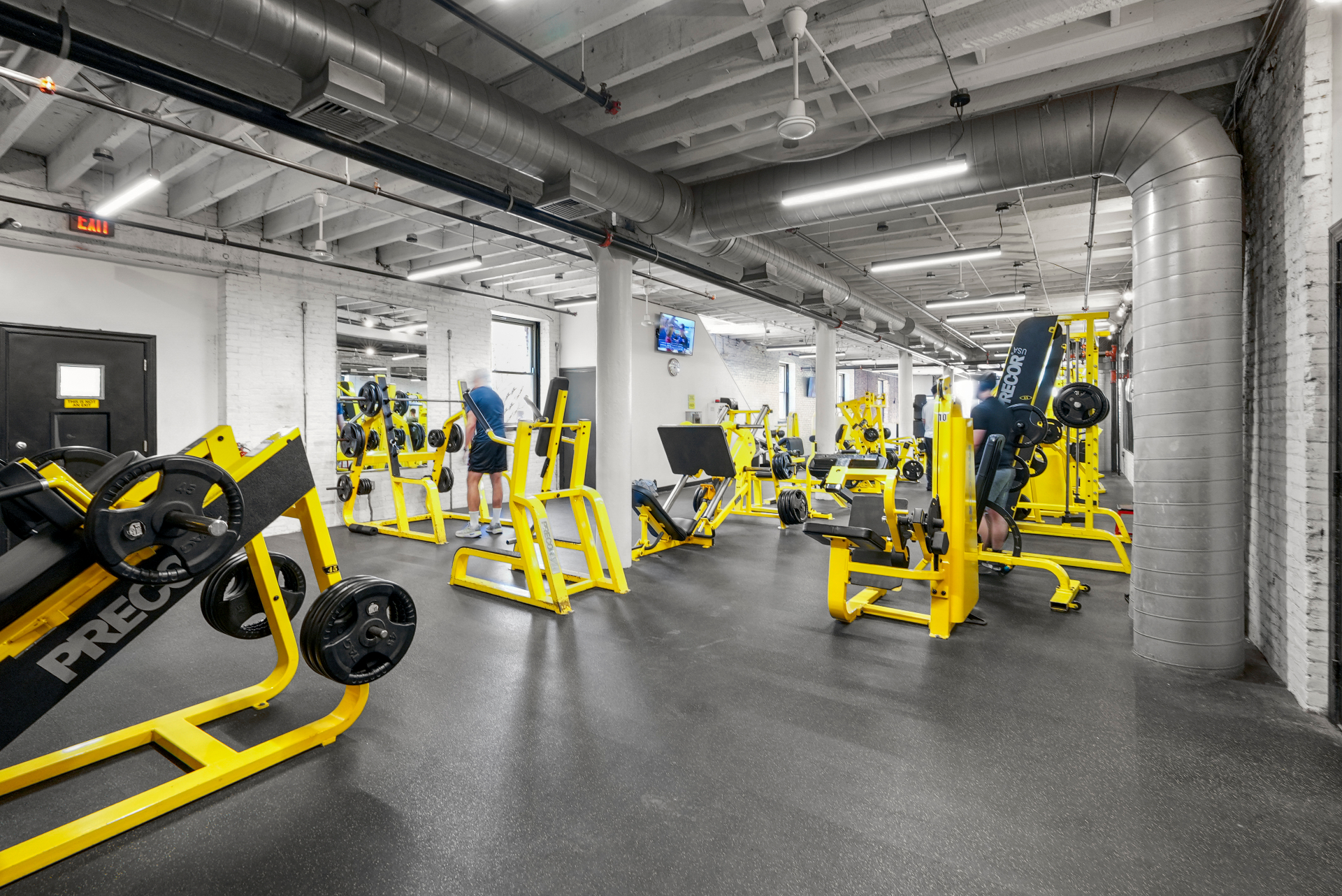 Plate-loaded room with signature yellow Precor equipment